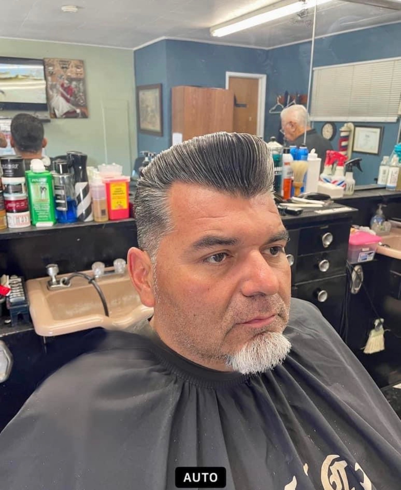 Sculpted pompadour haircut at Dapper B's Barbershop